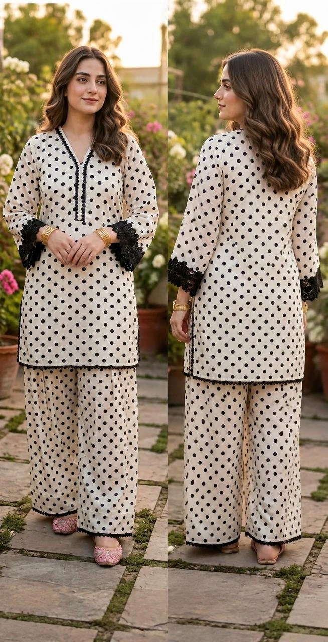 Black and white polka dot crepe short kurti paired with wide flared farshi pajama and black lace detailing